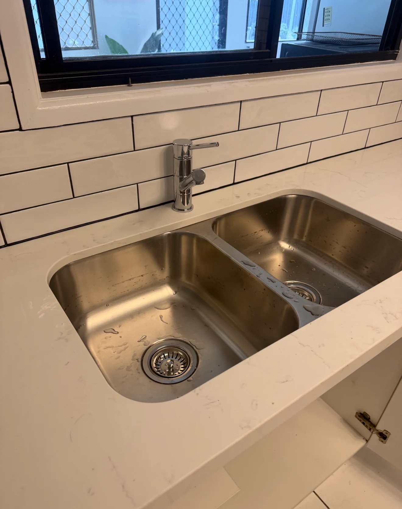 New kitchen mixer tap installed over a double sink