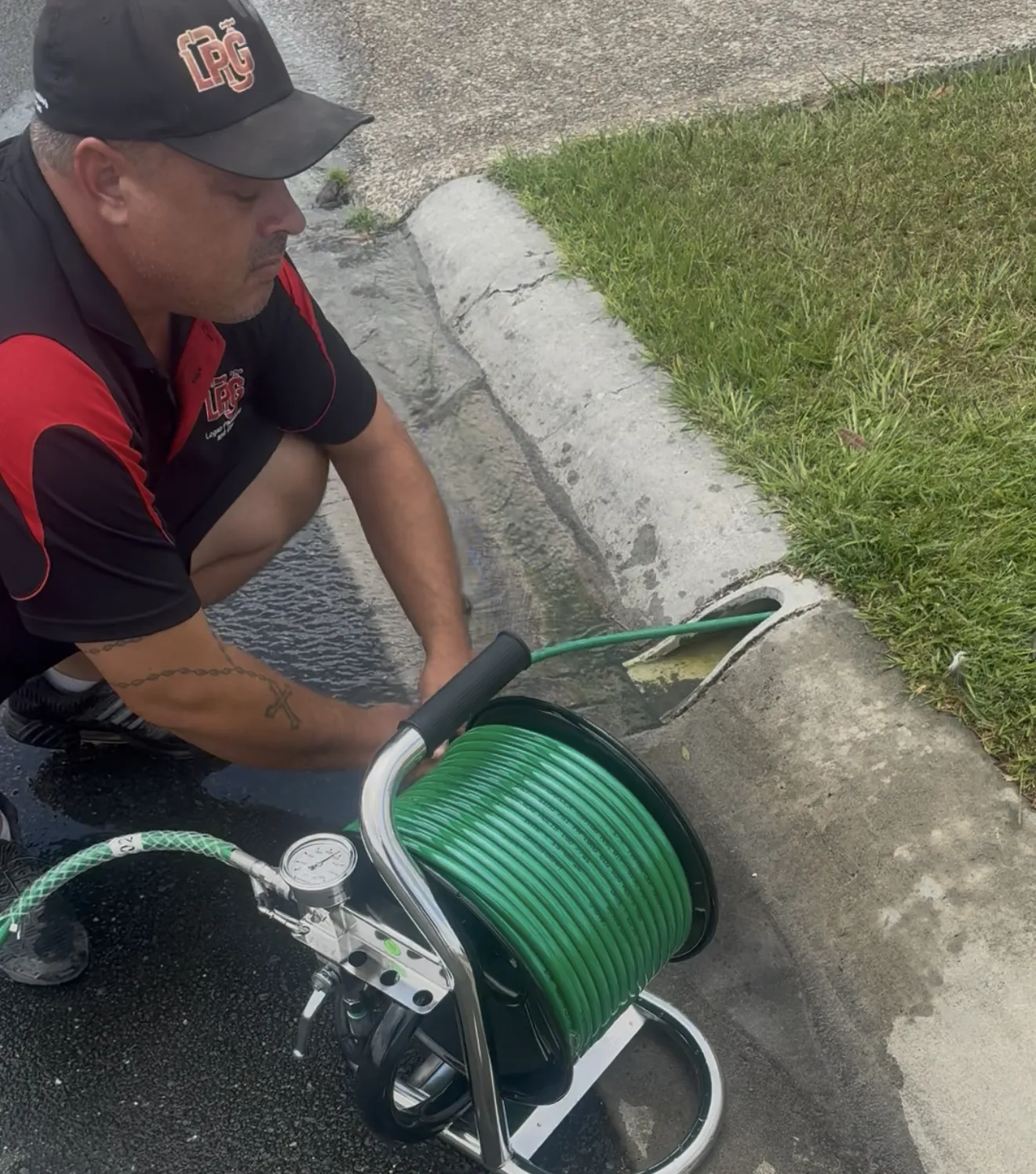 Plumber using a drain jetter to clear a blocked drain in Logan
