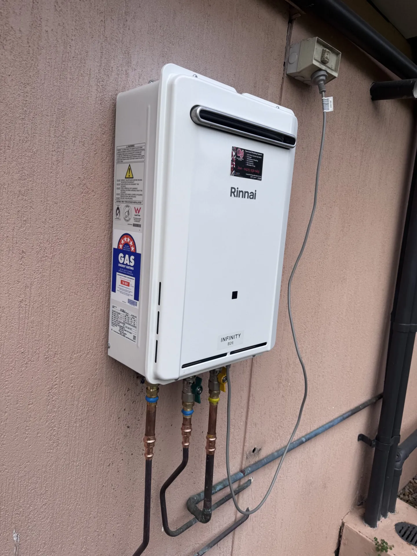 Continuous flow gas hot water unit mounted on an exterior wall